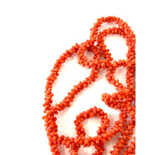 633 - Antique Georgian craved coral necklace. Weighs approx 54 grams. Measures approx 126 cm in length