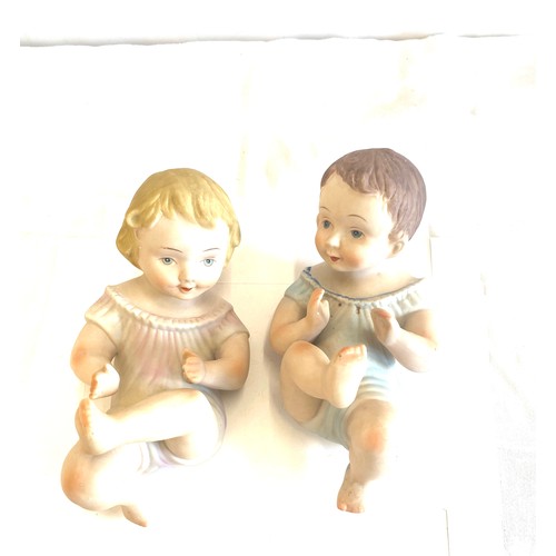 82 - Two piano baby pot figures measures approx 9 inches long