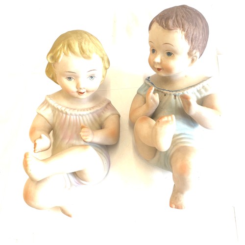 82 - Two piano baby pot figures measures approx 9 inches long