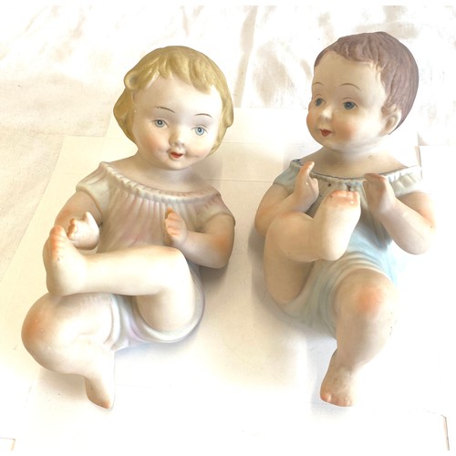 82 - Two piano baby pot figures measures approx 9 inches long