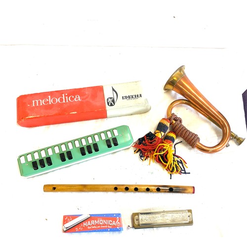 140 - Selection of vintage and later musical instruments to include military copper bugle, Hohner melodica... 