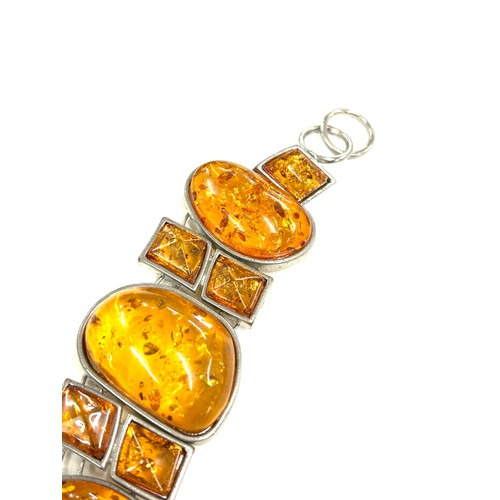 519 - Ladies silver and amber statement bracelet, approximate length