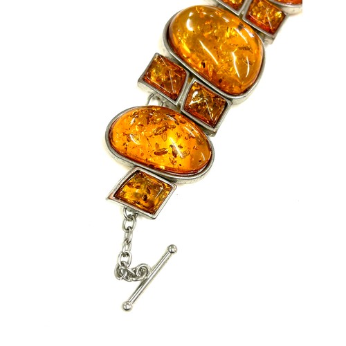 519 - Ladies silver and amber statement bracelet, approximate length