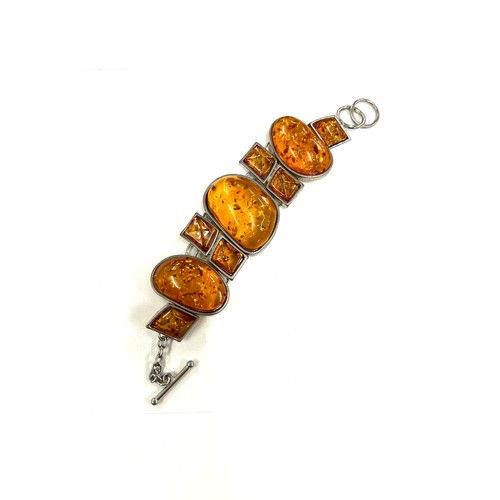 519 - Ladies silver and amber statement bracelet, approximate length