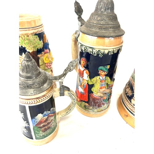 65 - Four vintage german steins largest measures approx 16 inches tall