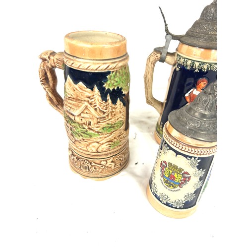 65 - Four vintage german steins largest measures approx 16 inches tall