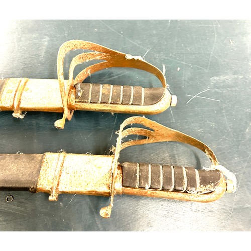 562A - Pair of vintage decorative swords with scabbards, marked made in India on the blades