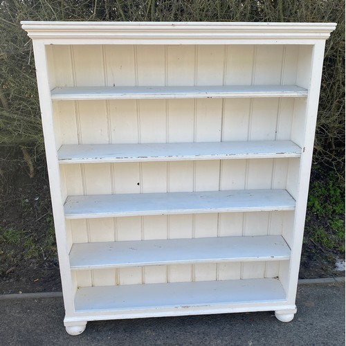 569 - 4 shelf painted bookcase measures approx 55 inches tall 44 inches wide 11 inches depth