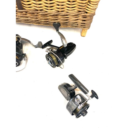 283 - Selection of fishing reels includes Shakespeare ball bearing 2210, New De lux all in a wicker fishin... 