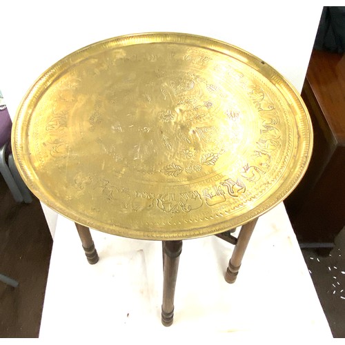 638 - Vintage brass topped carved wooden table, diameter approx 21 inches 22.5 inches diameter