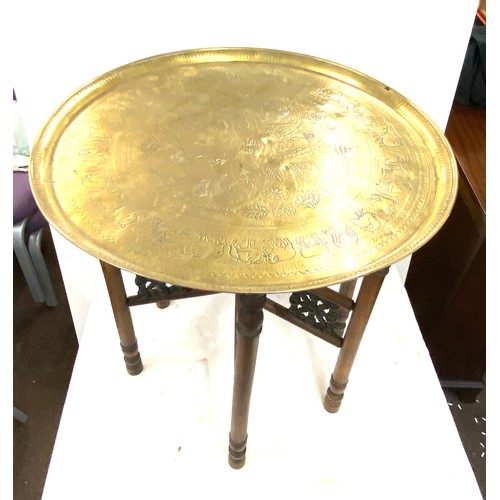 638 - Vintage brass topped carved wooden table, diameter approx 21 inches 22.5 inches diameter