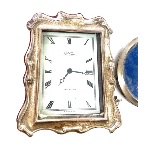 529 - Silver framed picture frame and a silver framed clock by R.Carr