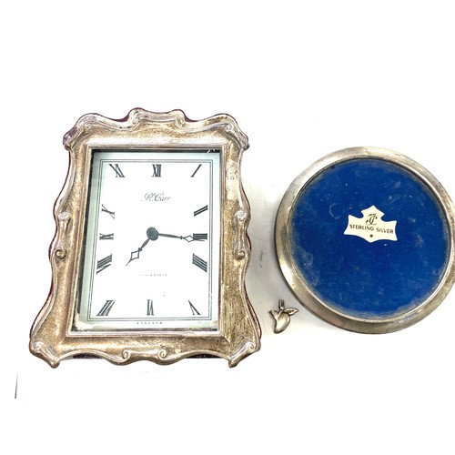 529 - Silver framed picture frame and a silver framed clock by R.Carr