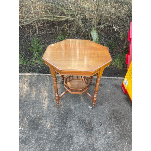 348 - Walnut octagonal table, on casters, measures approx 29 inches tall 29 inches by 29.5 inches