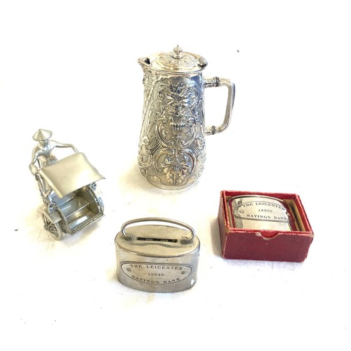 11 - Selection of silver plated items to include 2 Leicester money saving boxes, lidded jug and ricksaw m... 