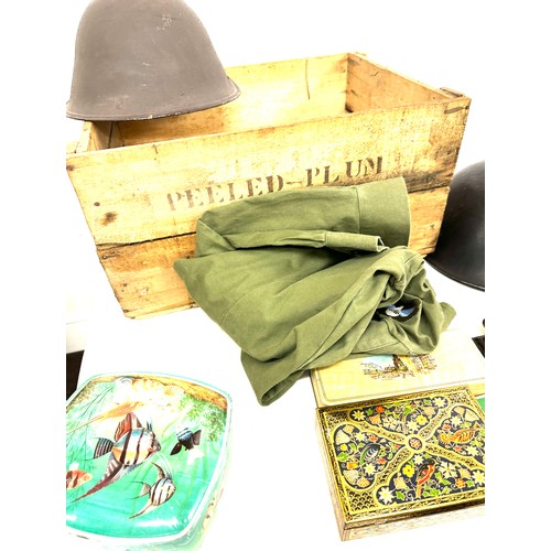 302 - Vintage tins, military helmets in a vintage tomato crate