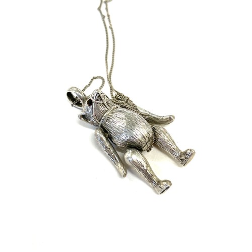 386 - Vintage novelty silver bear moving pendant with garnet set eyes on a silver chain