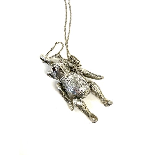 386 - Vintage novelty silver bear moving pendant with garnet set eyes on a silver chain