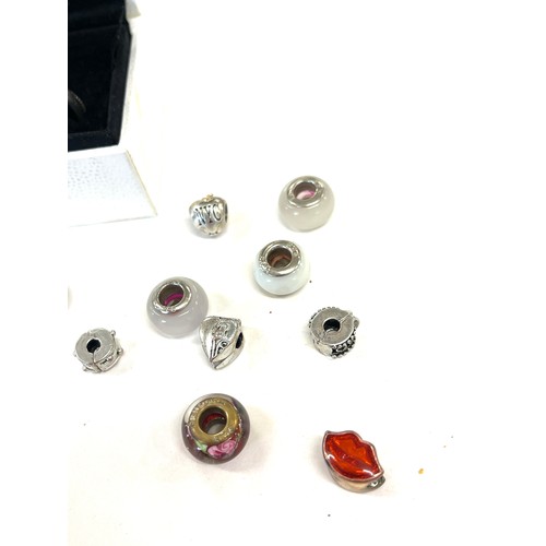 385 - Selection of silver charms includes pandora etc