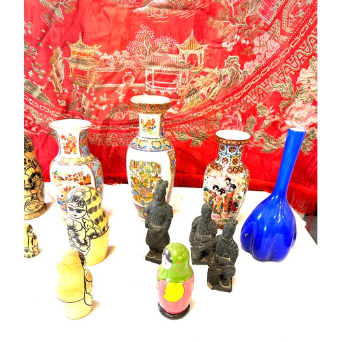 150 - Selection of oriental pottery includes Hand Painted vases, Russian dolls, Embroidered blanket etc