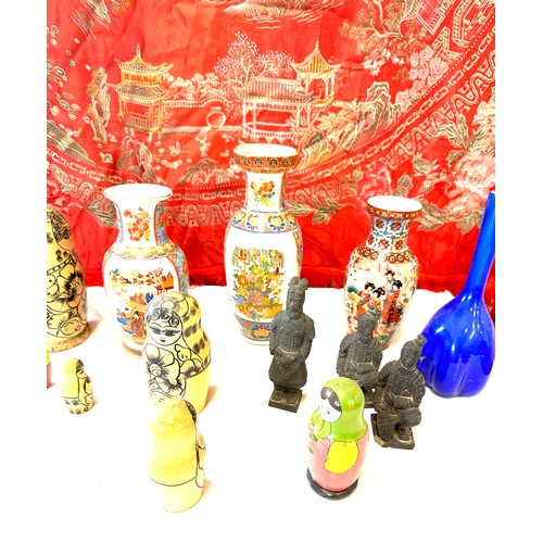 150 - Selection of oriental pottery includes Hand Painted vases, Russian dolls, Embroidered blanket etc