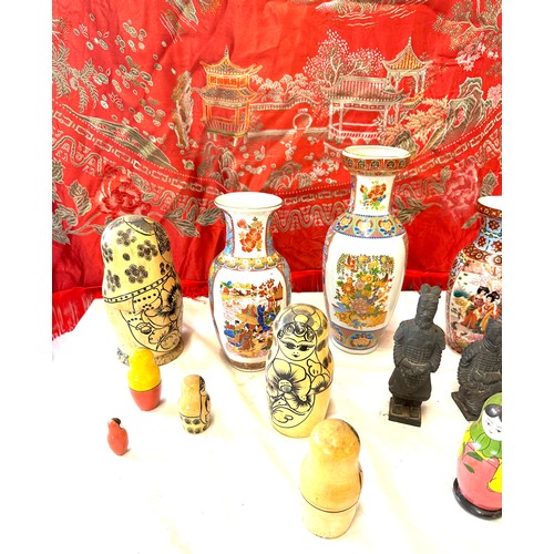 150 - Selection of oriental pottery includes Hand Painted vases, Russian dolls, Embroidered blanket etc