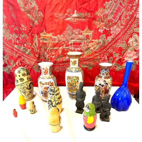 150 - Selection of oriental pottery includes Hand Painted vases, Russian dolls, Embroidered blanket etc