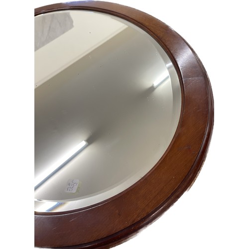 21 - Oval mahogany bevelled edge mirror measures approx 24 inches tall by 33.5 width