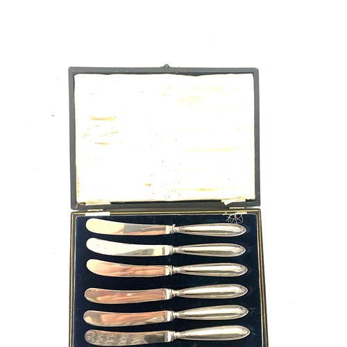 356 - Set of six silver butter knives in original box and a selection of silver spoons