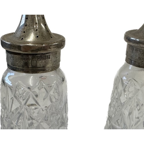 379 - Pair of silver lidded salt and pepper pot and a silver rimmed pot