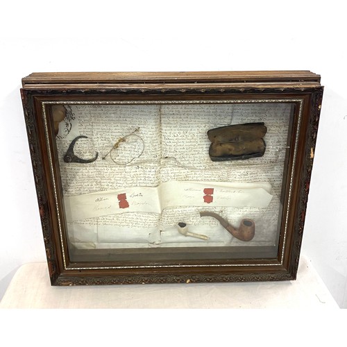 37 - Cased diorama includes spectacles and smoking pipes, case measures approx 16 inches by 21 inches