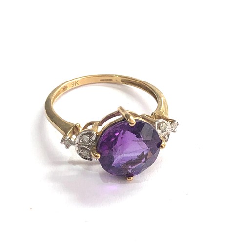 400 - 9ct Amethyst ring with floral diamond shoulders weight 2.4g