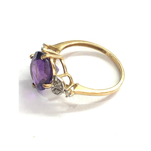 400 - 9ct Amethyst ring with floral diamond shoulders weight 2.4g