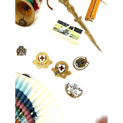 309 - Selection of collectable items includes letter openers, fans, badges, girl guide badge, good luck ba... 