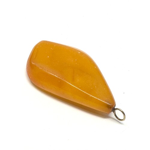 57 - 9ct  gold bail vintage egg yolk amber pendant (16.1g)