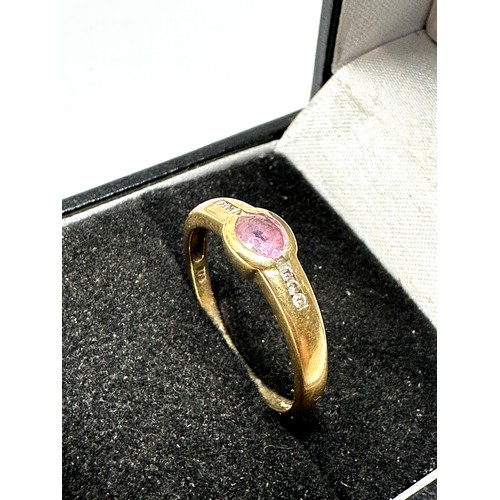 93 - 9ct yellow gold diamond & pink sapphire bezel ring (1.8g)