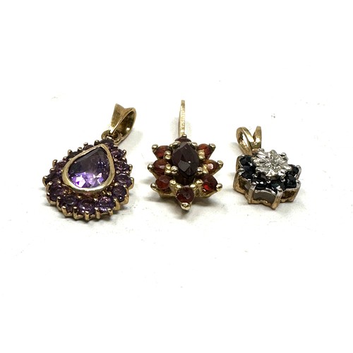 111 - 3 x 9ct yellow gold pendants inc. diamond, garnet, amethyst & sapphire (2.6g)