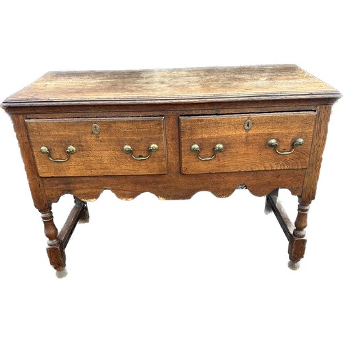 569 - Oak antique 2 drawer low side board measures approx 30 inches tall 43 inches wide 20 inches depth