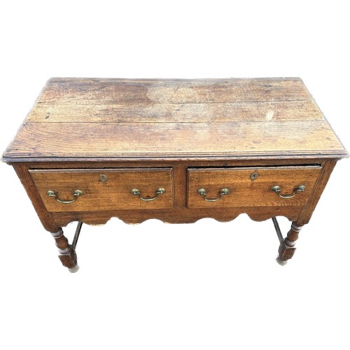 569 - Oak antique 2 drawer low side board measures approx 30 inches tall 43 inches wide 20 inches depth