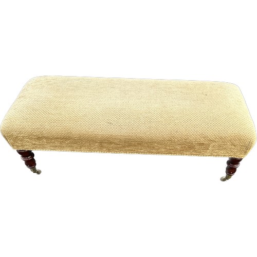 541 - Long foot stool on caster measures approximately 43 inches long 18 inches wide 15 inches tall