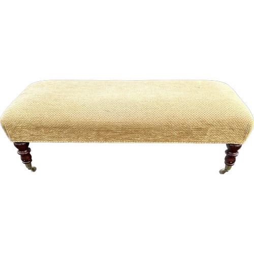 541 - Long foot stool on caster measures approximately 43 inches long 18 inches wide 15 inches tall