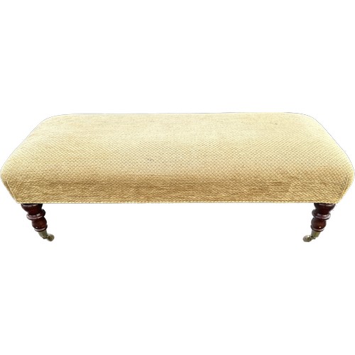 541 - Long foot stool on caster measures approximately 43 inches long 18 inches wide 15 inches tall