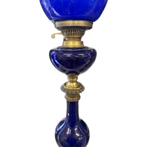 518 - Antique blue glass brass based oil lamp complete with funnel and shade