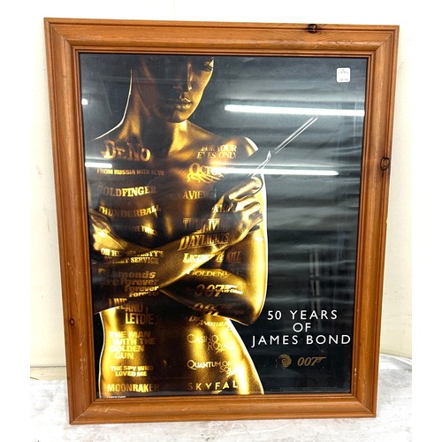 122 - Framed 50 Years of James Bond picture measures approximately 38.5 inches tall