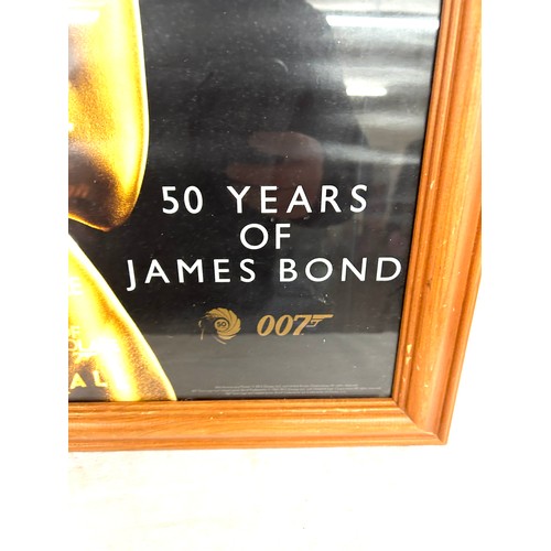 122 - Framed 50 Years of James Bond picture measures approximately 38.5 inches tall