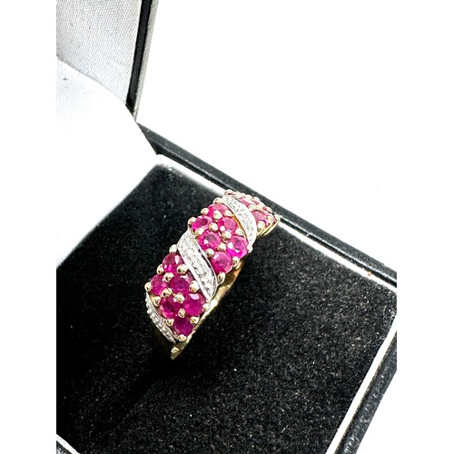 300 - 9ct gold diamond & ruby dress ring (2.6g)