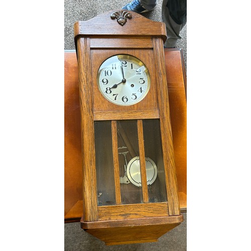 69 - 2 Keyhole oak framed wall clock, with key and pendulum measures approximately 31.5 inches tall