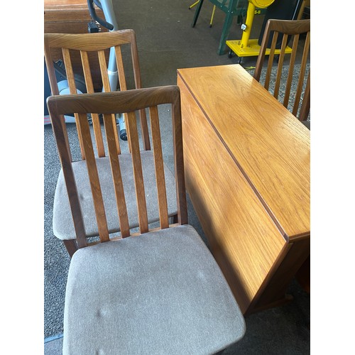 374 - G-Plan drop leaf table and 4 chairs table measures approximately 29 inches tall 52 inches wide and 3... 