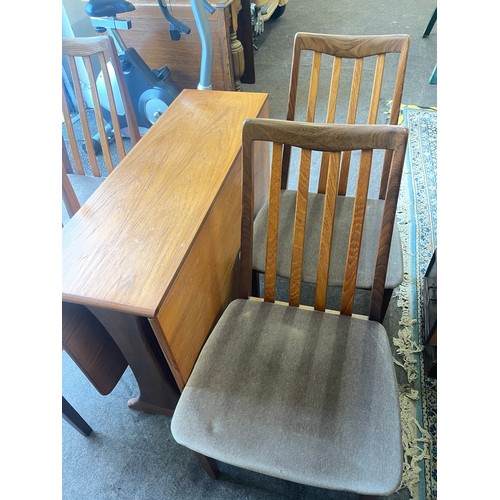 374 - G-Plan drop leaf table and 4 chairs table measures approximately 29 inches tall 52 inches wide and 3... 