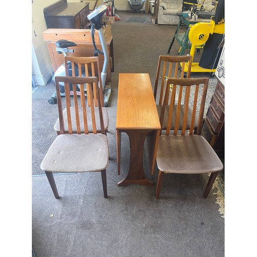 374 - G-Plan drop leaf table and 4 chairs table measures approximately 29 inches tall 52 inches wide and 3... 